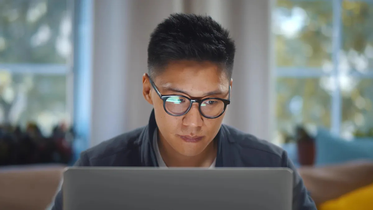 Close up of man staring at information on computer