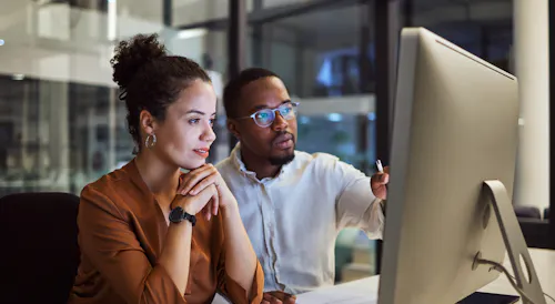 Man and woman working on cybersecurity problem together