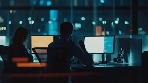 Man working in busy office at night
