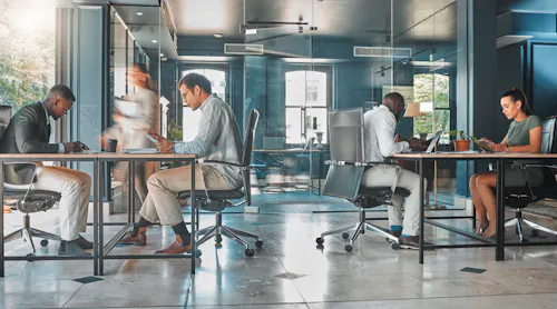 People working in a busy tech office