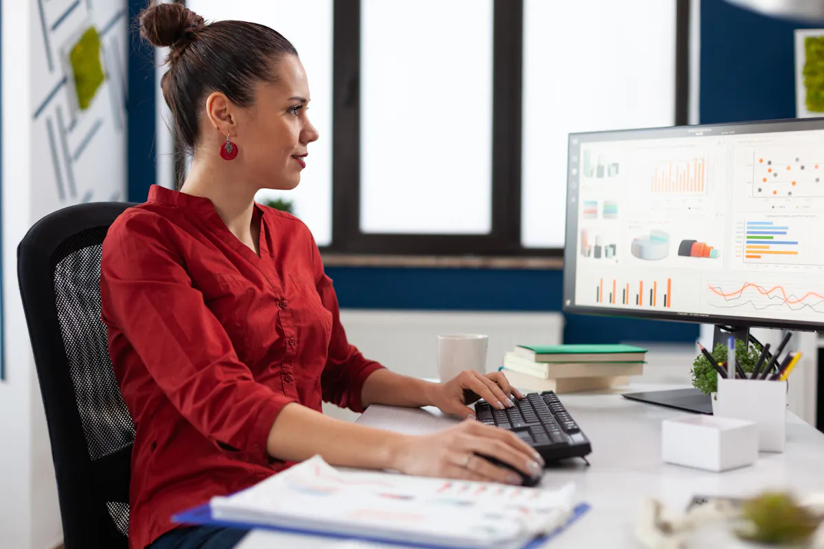 Woman in red shirt looking at data
