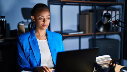 Woman working at desk in blue blazer