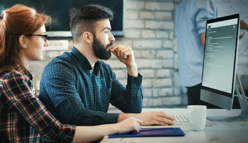 Woman and man learning coding skills